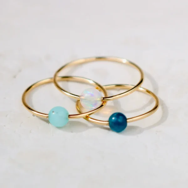 Gold rings with colorful gemstone beads.