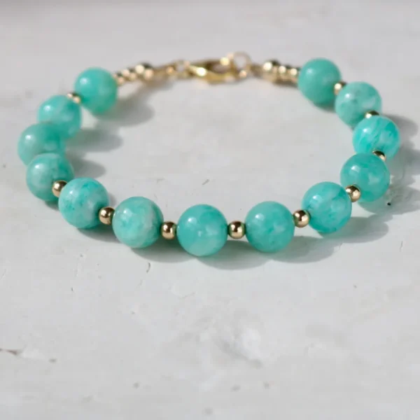 Turquoise bead bracelet with gold accents.