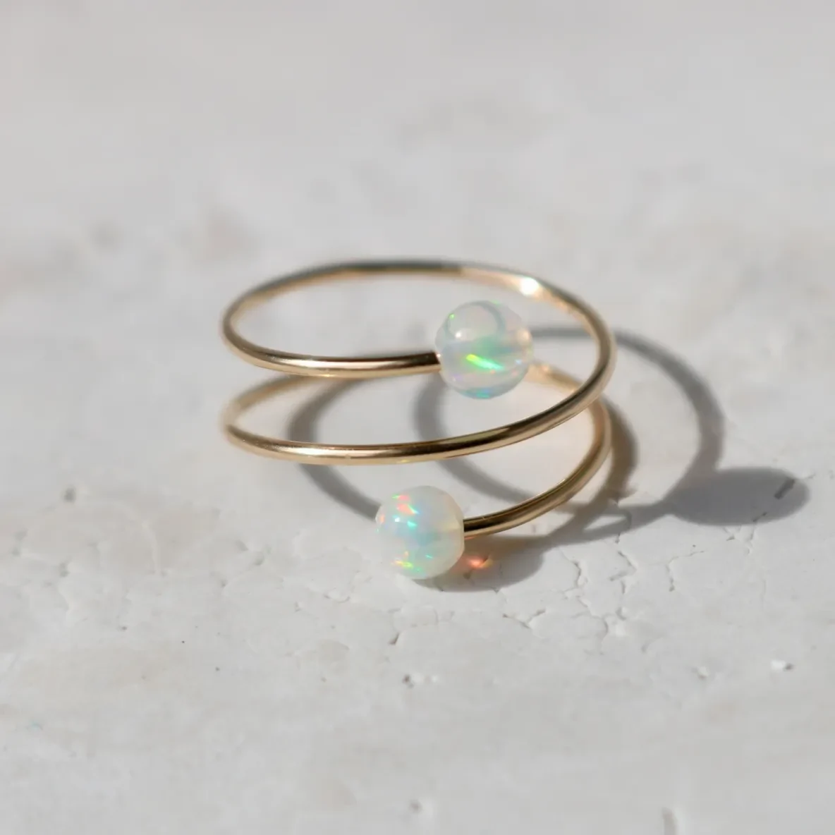 Gold spiral ring with opal beads.